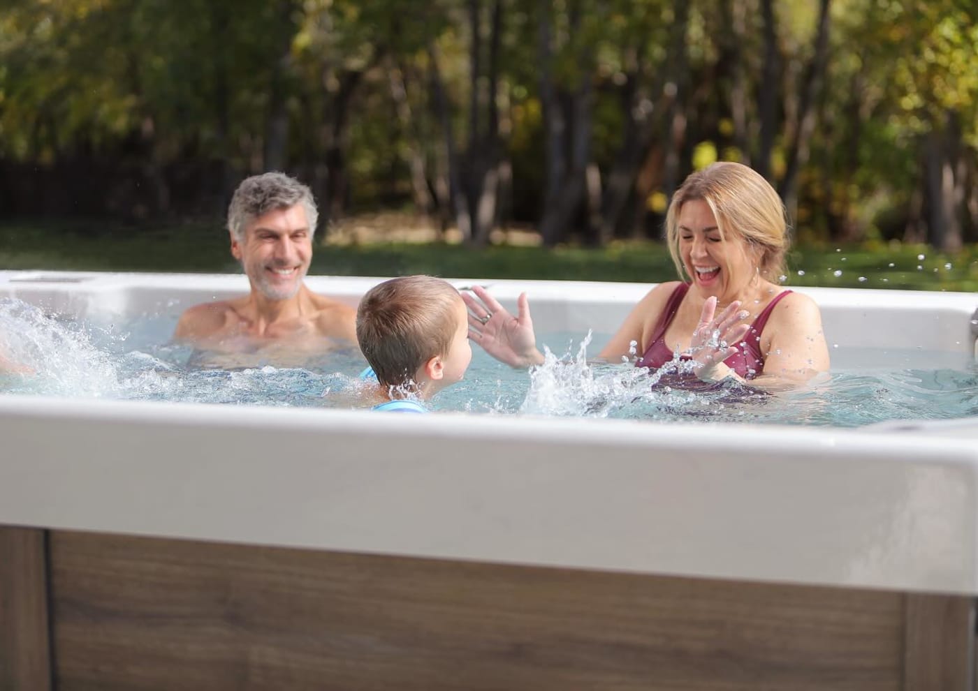 A family is playing in a hot tub.